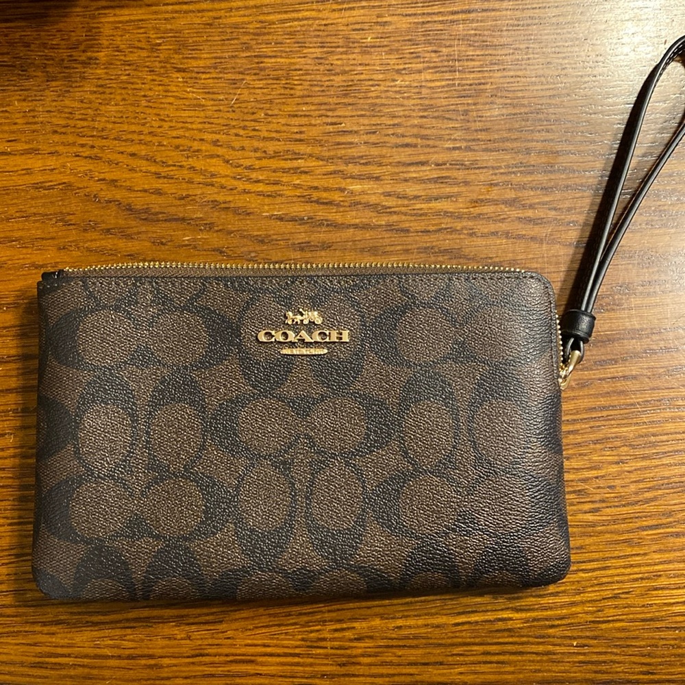 Coach large wristlet in signature black/brown.